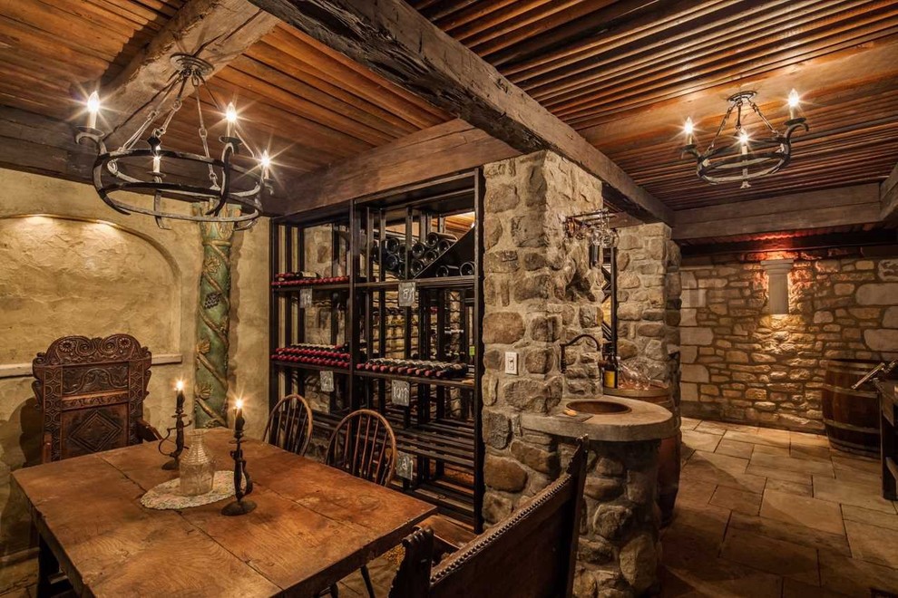 Inspiration for a large mediterranean wine cellar in Philadelphia with storage racks, limestone floors and beige floor.