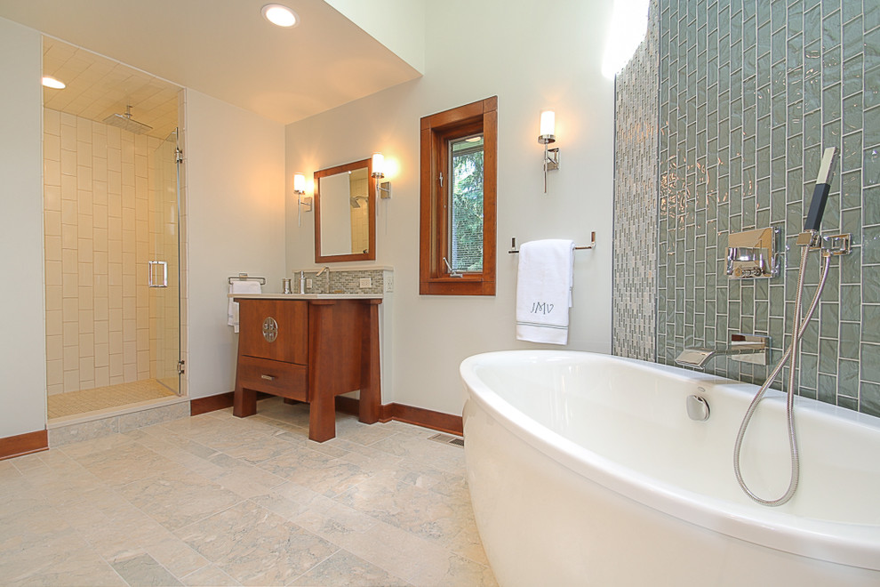 Inspiration for a large asian master bathroom in Chicago with flat-panel cabinets, medium wood cabinets, a freestanding tub, an alcove shower, blue tile, glass tile, white walls, marble floors, an undermount sink and solid surface benchtops.