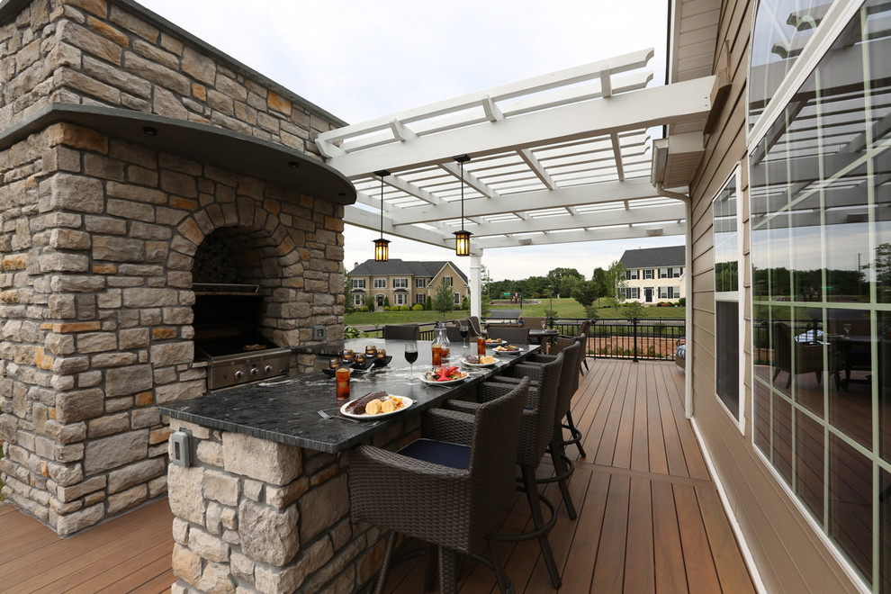 Inspiration for a large contemporary backyard deck in Philadelphia with an outdoor kitchen and a pergola.