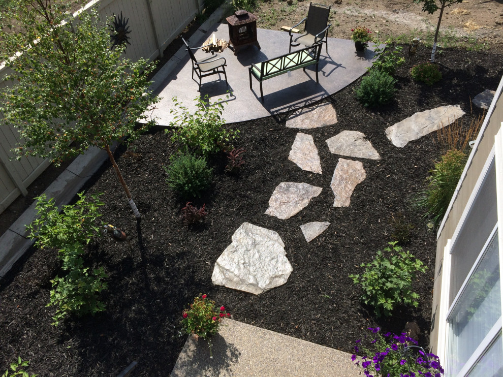Photo of a small backyard patio in Calgary with a fire feature and concrete slab.