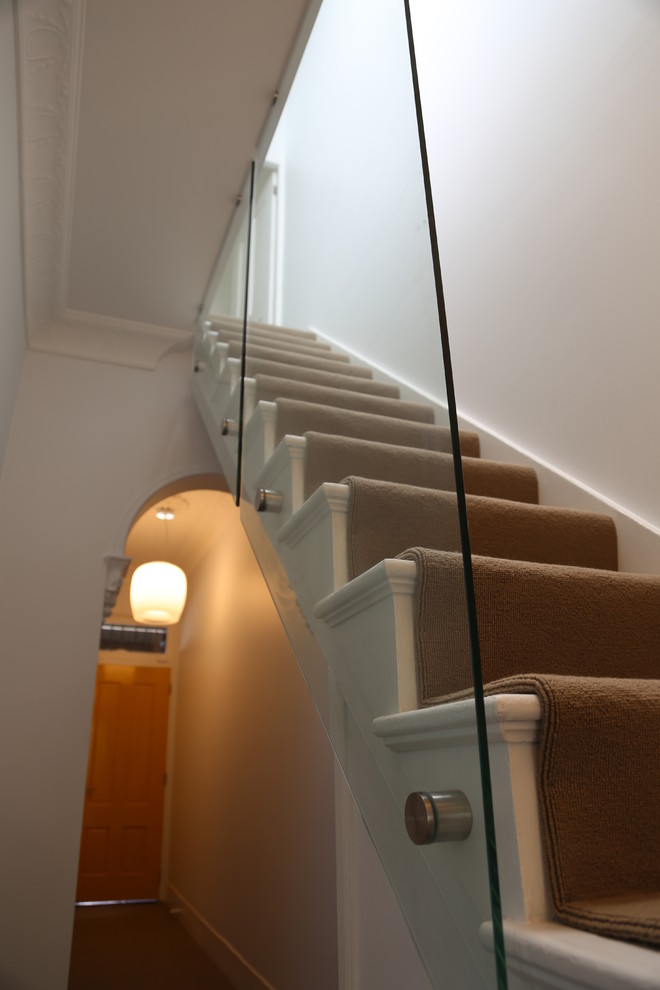 Photo of a small modern carpeted straight staircase in Sydney with carpet risers.