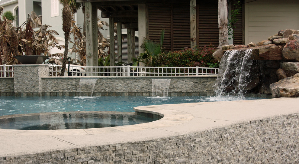 Inspiration for a small traditional side yard custom-shaped natural pool in Houston with a hot tub and natural stone pavers.