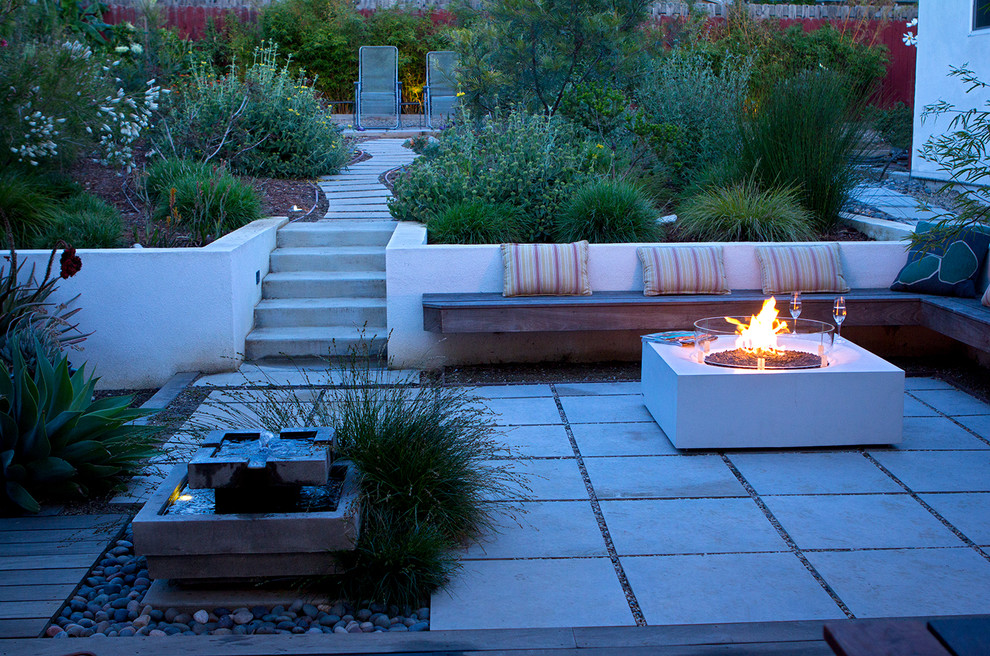 Design ideas for a large contemporary backyard xeriscape in Los Angeles with a fire feature and concrete pavers.
