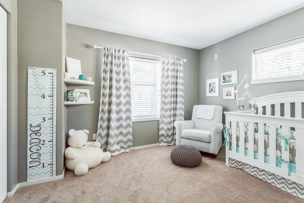 This is an example of a traditional gender-neutral nursery in Seattle with grey walls and carpet.