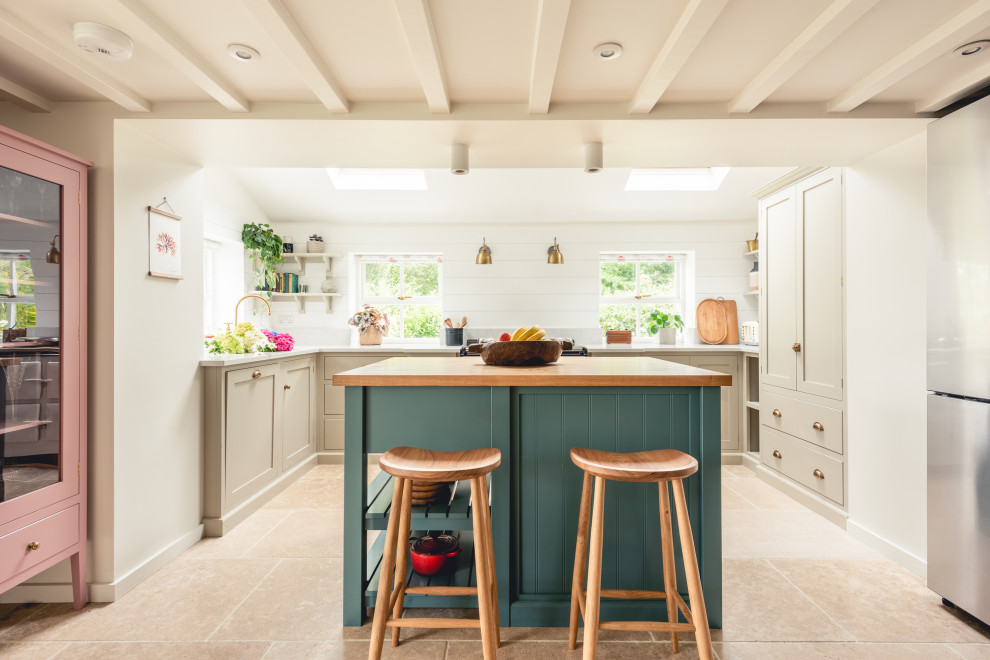 Design ideas for a mid-sized country u-shaped kitchen in Cardiff with shaker cabinets, beige cabinets, panelled appliances, porcelain floors, with island, beige floor and beige benchtop.
