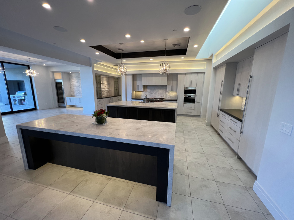 Inspiration for an expansive contemporary open plan kitchen in Phoenix with multiple islands.