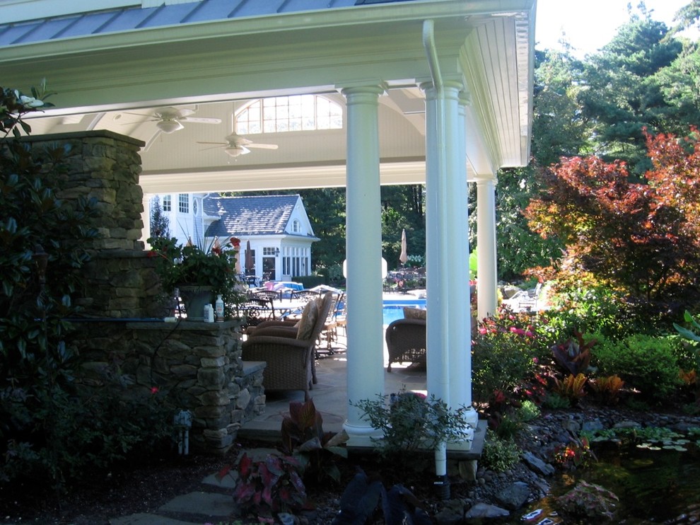 Photo of a traditional backyard patio in New York with decking and a gazebo/cabana.