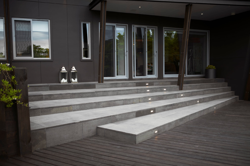 Expansive contemporary backyard garden in Sydney with a retaining wall.