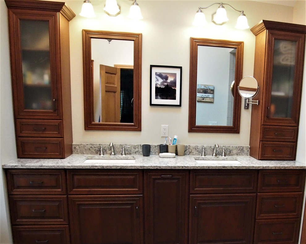 Photo of a large traditional master bathroom in Bridgeport with raised-panel cabinets, medium wood cabinets, a freestanding tub, an alcove shower, a two-piece toilet, beige tile, porcelain tile, orange walls, porcelain floors, an undermount sink, quartzite benchtops, multi-coloured floor and a hinged shower door.