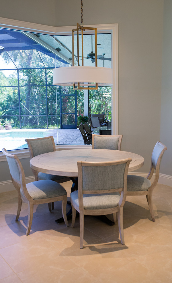 This is an example of a small beach style open plan dining in Miami with grey walls, ceramic floors, no fireplace and beige floor.