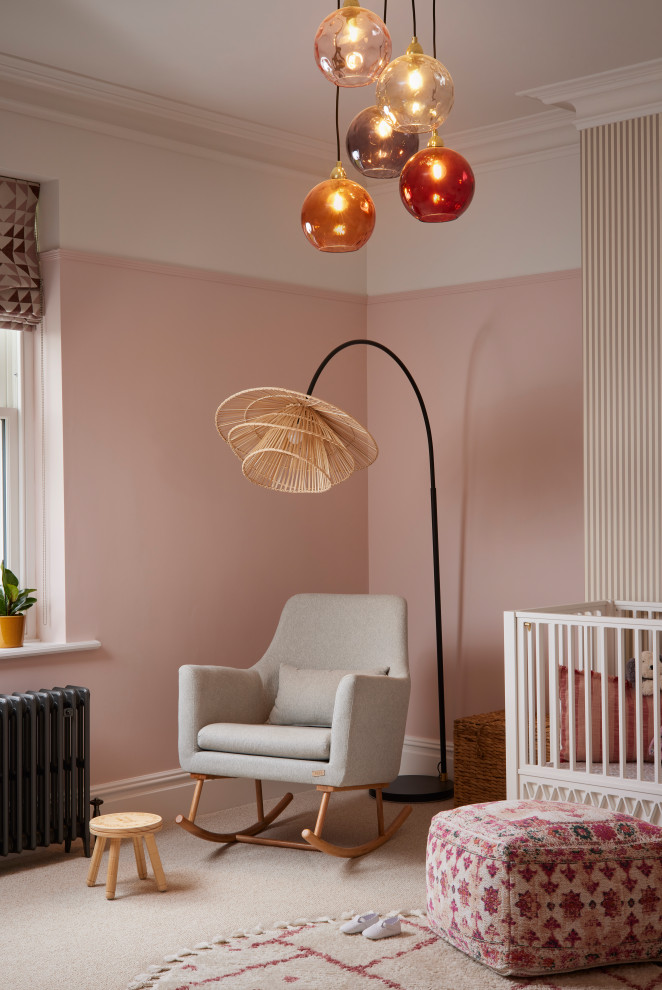Design ideas for a transitional nursery in Other with pink walls and carpet.