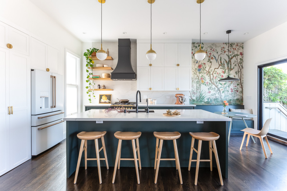 Inspiration for a mid-sized zen single-wall medium tone wood floor eat-in kitchen remodel in San Francisco with flat-panel cabinets, black appliances, an island and white countertops