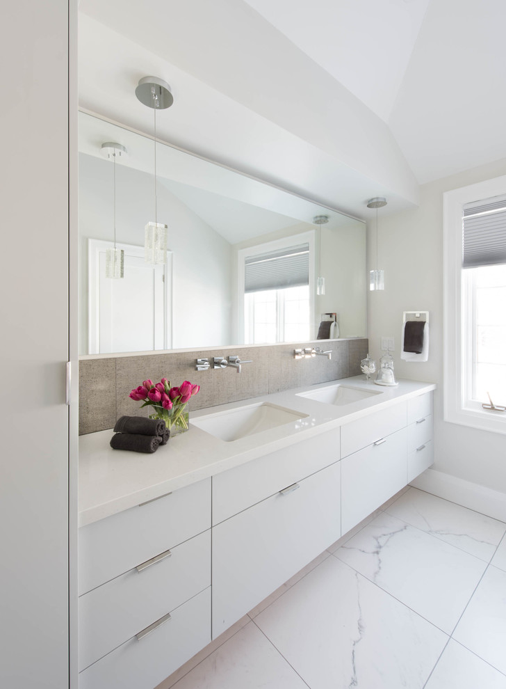 Design ideas for a mid-sized contemporary master bathroom in Toronto with an undermount sink, flat-panel cabinets, white cabinets, quartzite benchtops, gray tile, porcelain tile, white walls, porcelain floors and white benchtops.