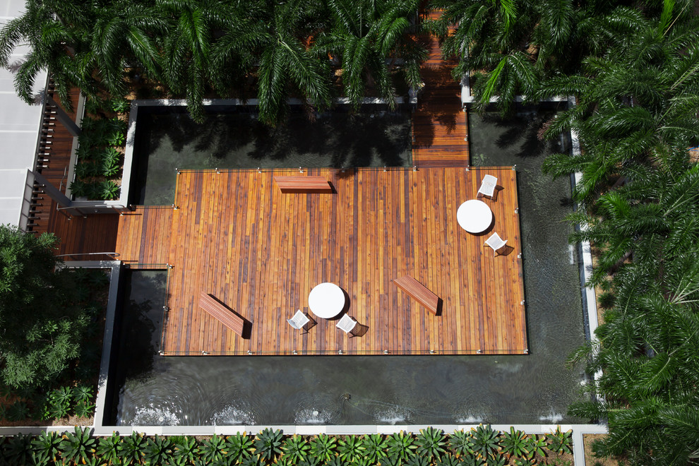 Photo of a tropical rooftop partial sun outdoor sport court in Miami with decking.
