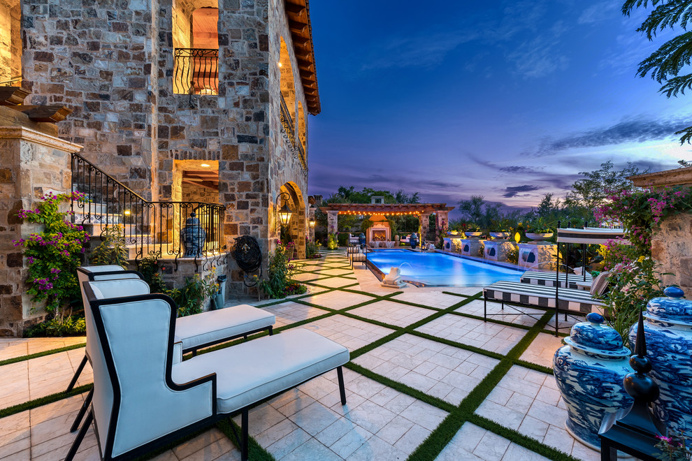 Patio - huge transitional backyard concrete paver patio idea in Phoenix with a fireplace and no cover