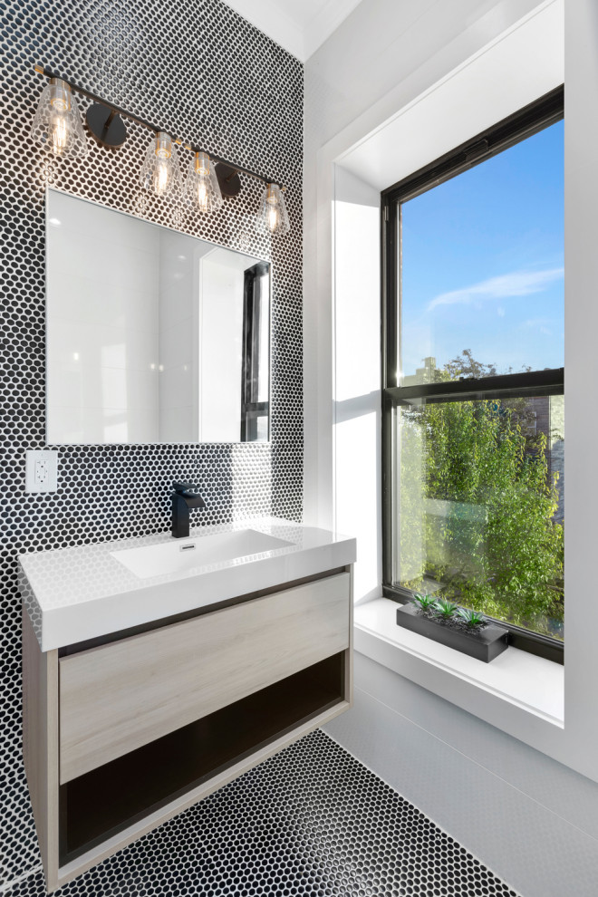 Example of a large trendy master black and white tile and mosaic tile porcelain tile, gray floor and double-sink bathroom design in New York with flat-panel cabinets, white cabinets, a one-piece toilet, white walls, an integrated sink, marble countertops, black countertops and a freestanding vanity