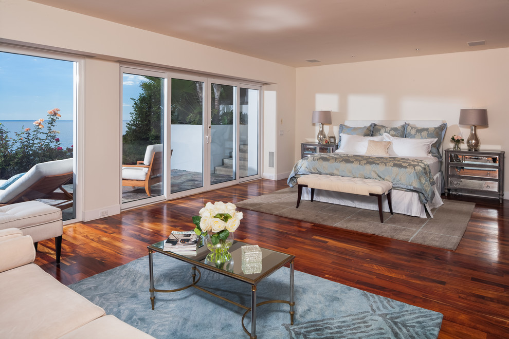 Transitional bedroom in Orange County with beige walls and dark hardwood floors.