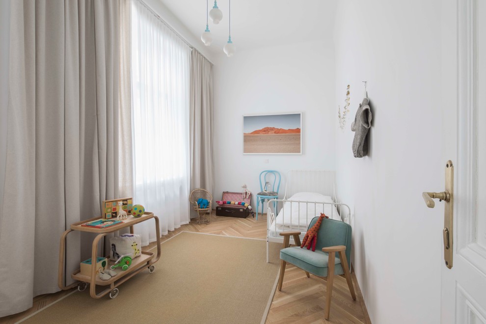 Mid-sized midcentury toddler room in Other with white walls, medium hardwood floors and brown floor.