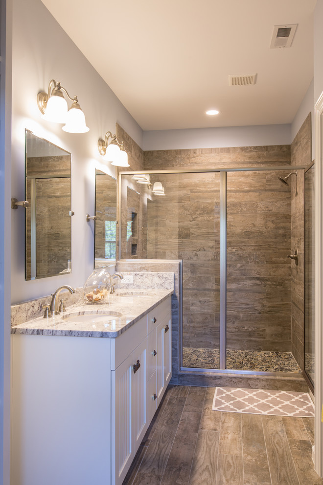 Design ideas for a mid-sized beach style master bathroom in Other with shaker cabinets, white cabinets, a corner shower, gray tile, mosaic tile, grey walls, an undermount sink, granite benchtops and ceramic floors.