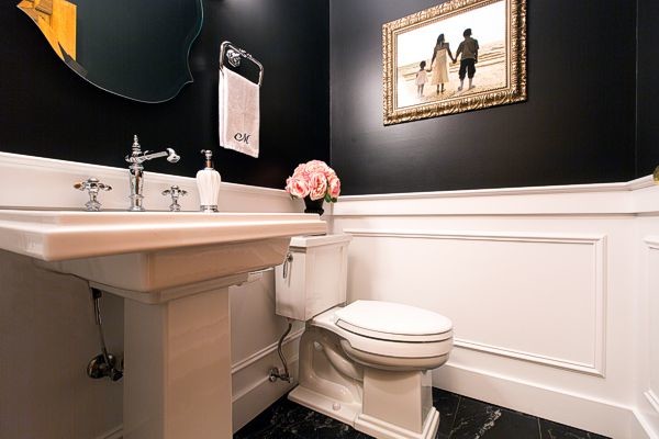 Small traditional powder room in Chicago with a pedestal sink, a two-piece toilet, black tile and black walls.