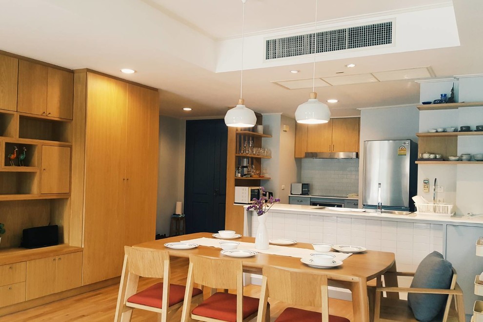 Kitchen/dining room combo - small zen medium tone wood floor and brown floor kitchen/dining room combo idea with gray walls and no fireplace