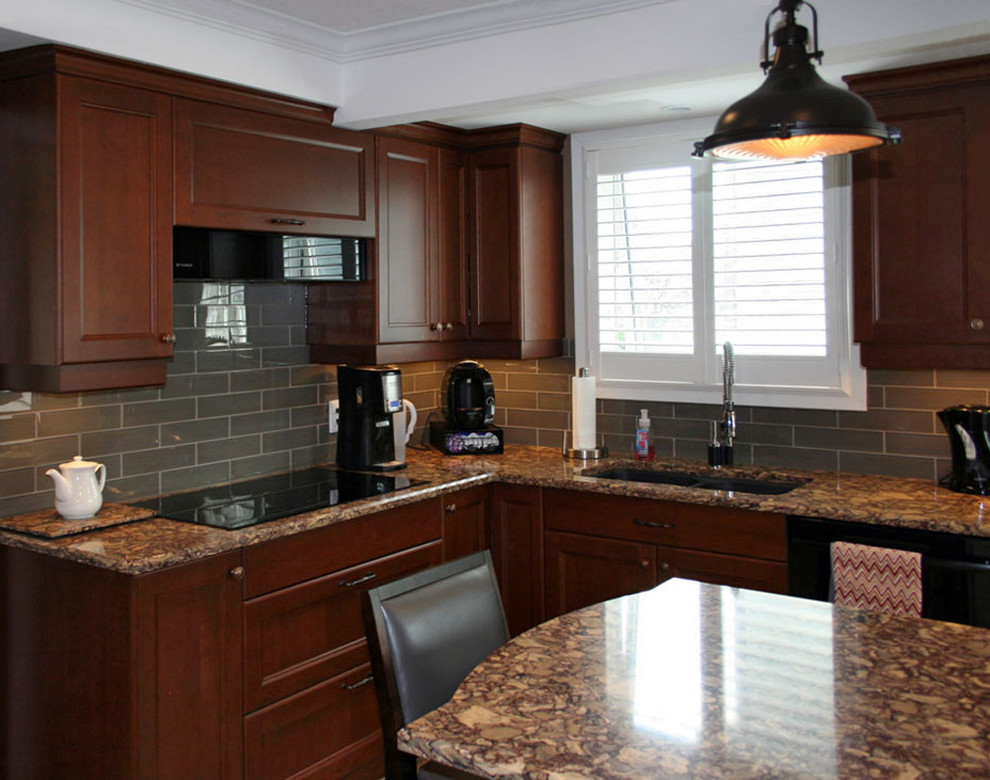 Example of a mid-sized transitional l-shaped linoleum floor enclosed kitchen design in Toronto with an undermount sink, shaker cabinets, medium tone wood cabinets, quartz countertops, gray backsplash, ceramic backsplash, black appliances and an island