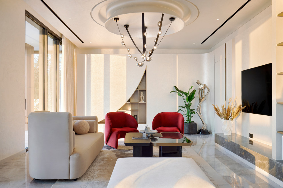 Contemporary living room in Mumbai With White Walls, a Wall-mounted TV and Gray.