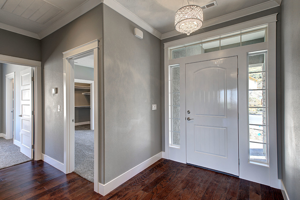 Inspiration for a small transitional medium tone wood floor front door remodel in Seattle with gray walls and a white front door
