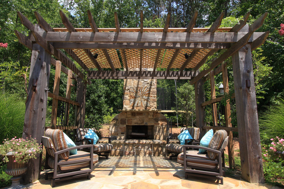 Mountain style stone patio photo in Atlanta with a fire pit and a pergola