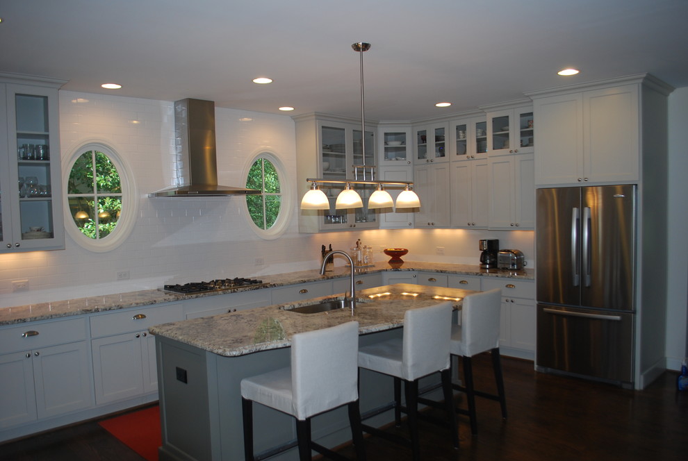 Inspiration for a contemporary l-shaped kitchen in Atlanta with a single-bowl sink, shaker cabinets, white cabinets, granite benchtops, white splashback, subway tile splashback, stainless steel appliances, dark hardwood floors and with island.