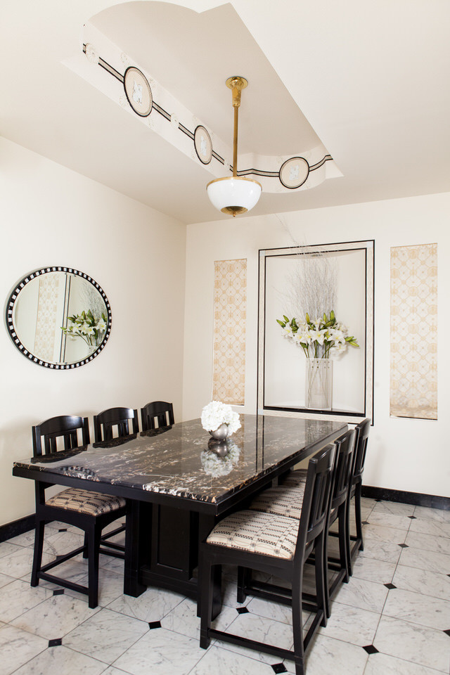 This is an example of an expansive transitional separate dining room in New York with white walls and marble floors.