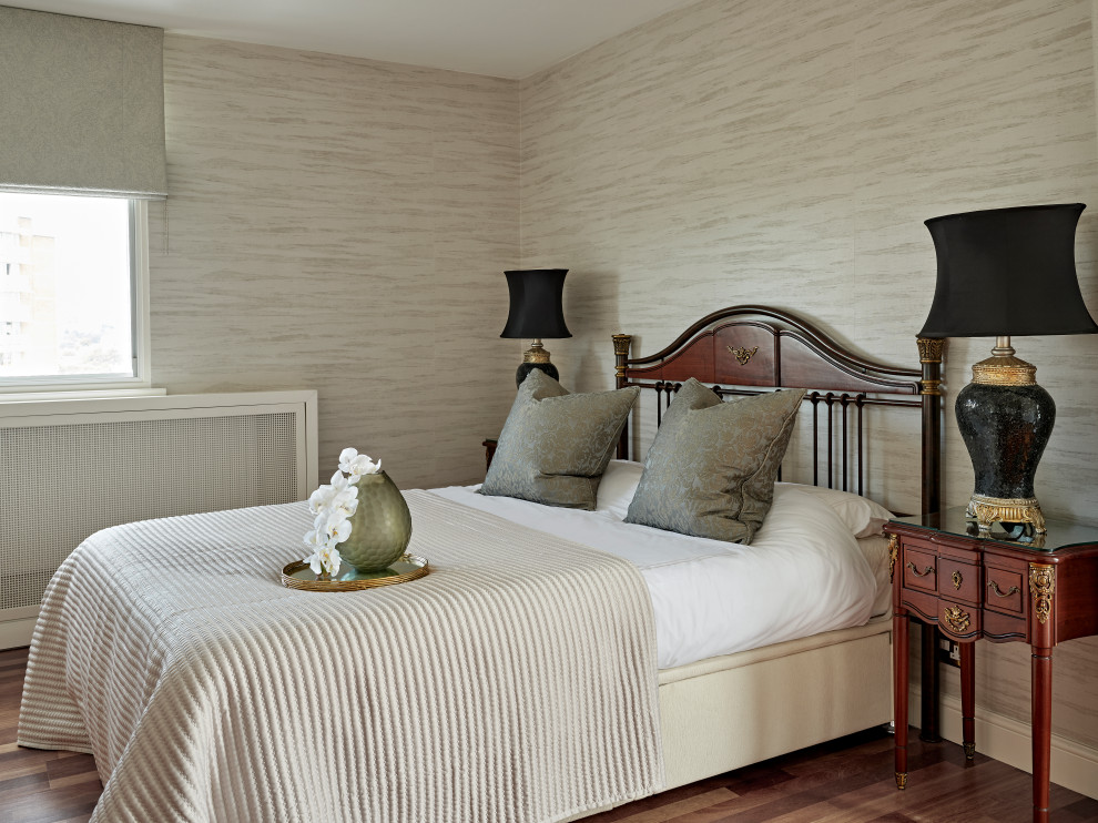 Design ideas for a transitional bedroom in Buckinghamshire with beige walls, dark hardwood floors, brown floor and wallpaper.