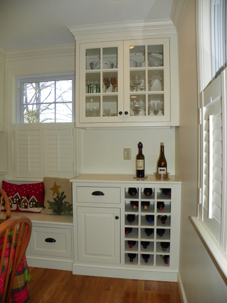 Mid-sized transitional u-shaped light wood floor eat-in kitchen photo in Boston with an undermount sink, beaded inset cabinets, white cabinets, quartz countertops, white backsplash, subway tile backsplash, stainless steel appliances and no island