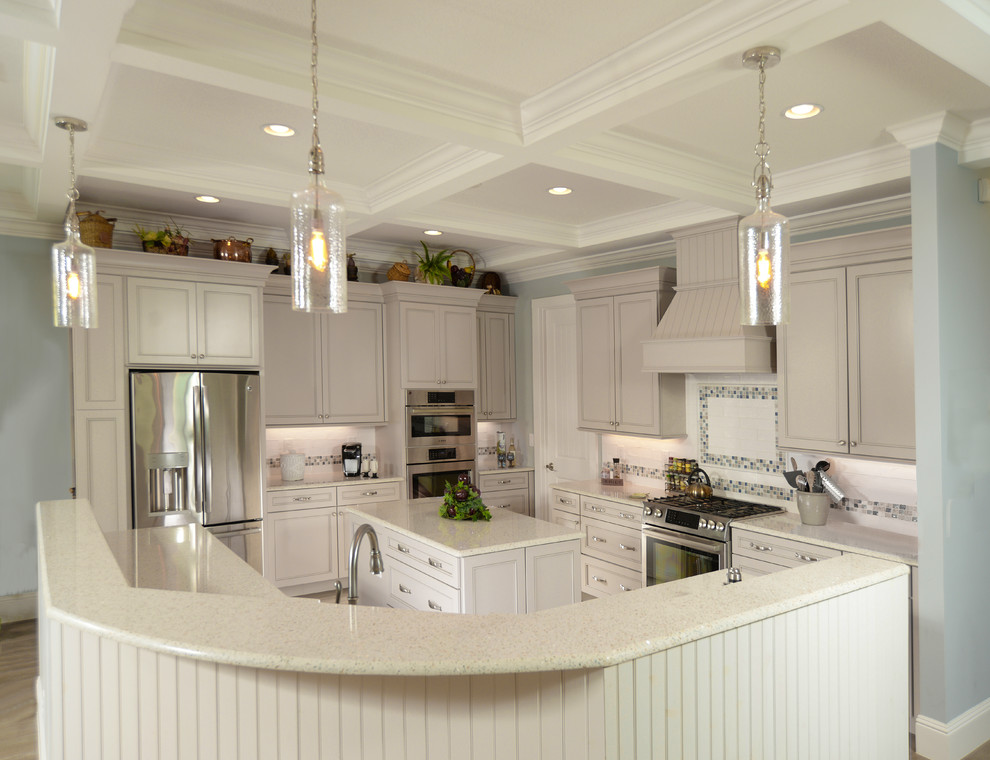 Photo of a large transitional u-shaped kitchen pantry in Orlando with a drop-in sink, shaker cabinets, grey cabinets, recycled glass benchtops, white splashback, glass sheet splashback, stainless steel appliances, porcelain floors, multiple islands, grey floor and multi-coloured benchtop.