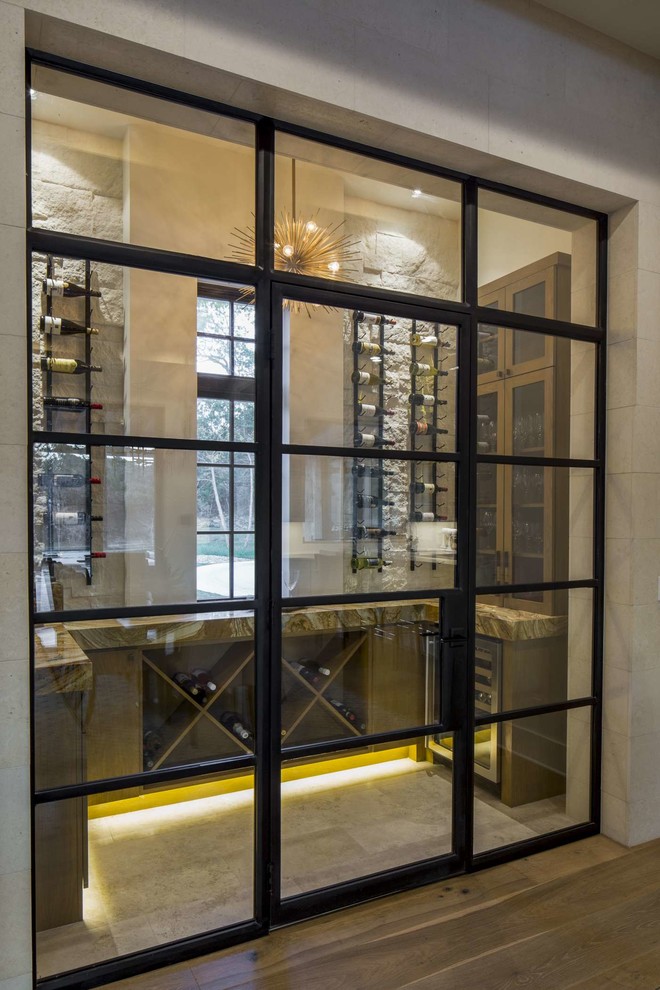 Design ideas for a mid-sized transitional wine cellar in Austin with display racks, brown floor and porcelain floors.