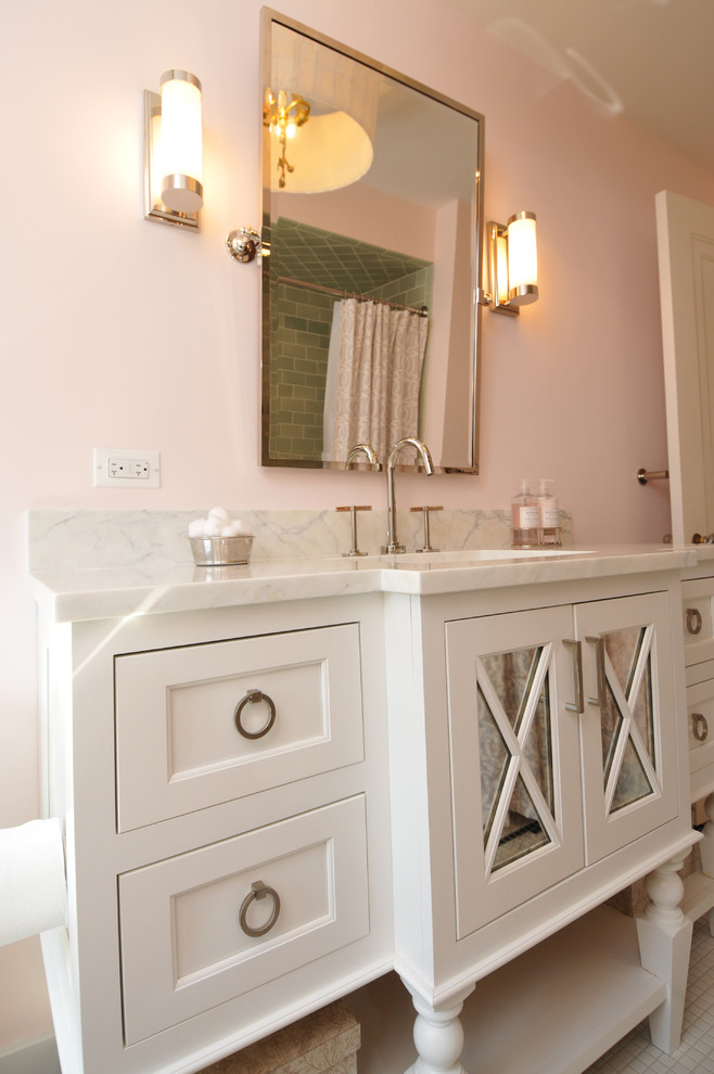 Mid-sized traditional kids bathroom in Chicago with furniture-like cabinets, white cabinets, an alcove tub, a shower/bathtub combo, a one-piece toilet, green tile, glass tile, pink walls, an undermount sink, marble benchtops and ceramic floors.