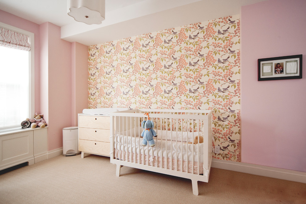 Inspiration for a mid-sized transitional nursery for girls in New York with pink walls, carpet and beige floor.