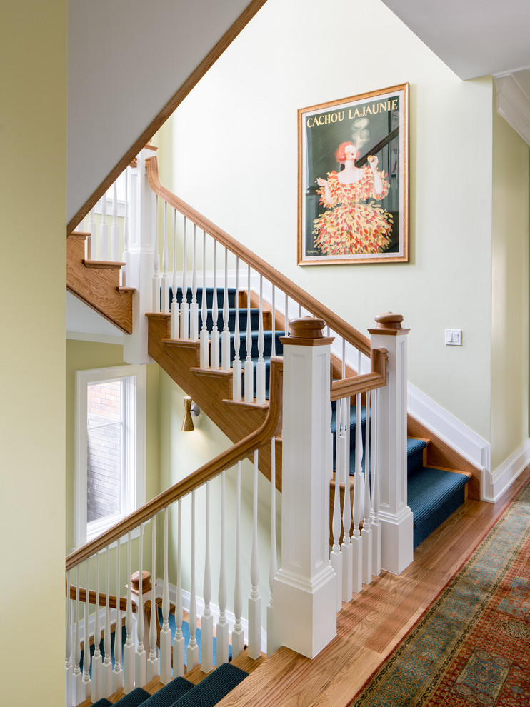 Inspiration for a traditional carpeted u-shaped staircase in Denver with wood railing and carpet risers.