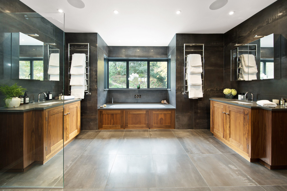 Inspiration for a transitional master bathroom in London with shaker cabinets, medium wood cabinets, an alcove tub, black tile, gray tile, black walls, an undermount sink, grey floor and an open shower.