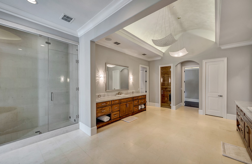 Huge transitional master white tile and stone tile limestone floor and white floor freestanding bathtub photo in Orange County with shaker cabinets, dark wood cabinets, a one-piece toilet, gray walls, a drop-in sink and quartzite countertops