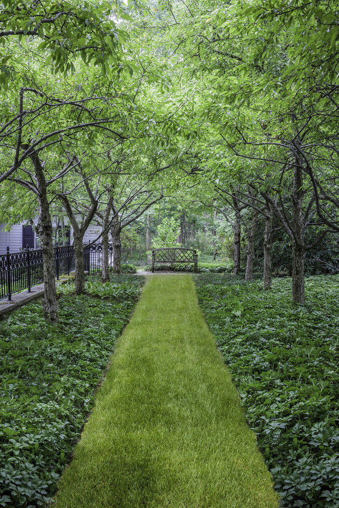 Traditional shaded garden in Cleveland with a garden path.