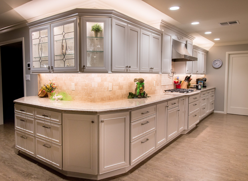 Inspiration for a huge transitional open concept kitchen remodel with a farmhouse sink, recessed-panel cabinets, white cabinets, quartz countertops, beige backsplash, stone tile backsplash, stainless steel appliances and an island