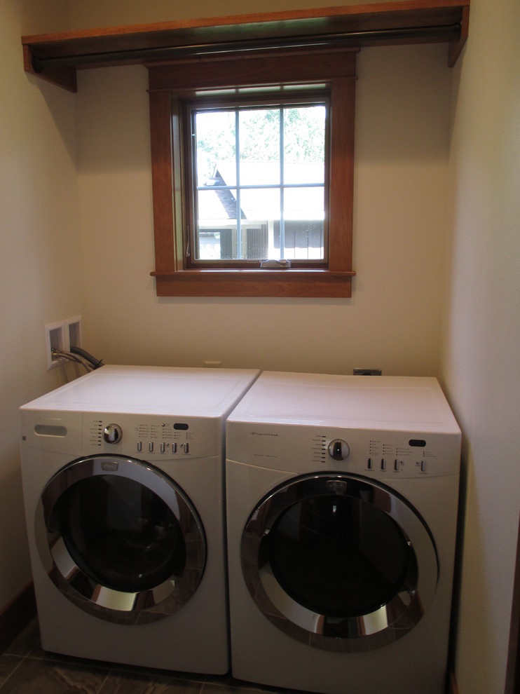 Inspiration for a small transitional laundry room in Other with a drop-in sink, recessed-panel cabinets, medium wood cabinets, laminate benchtops and a side-by-side washer and dryer.