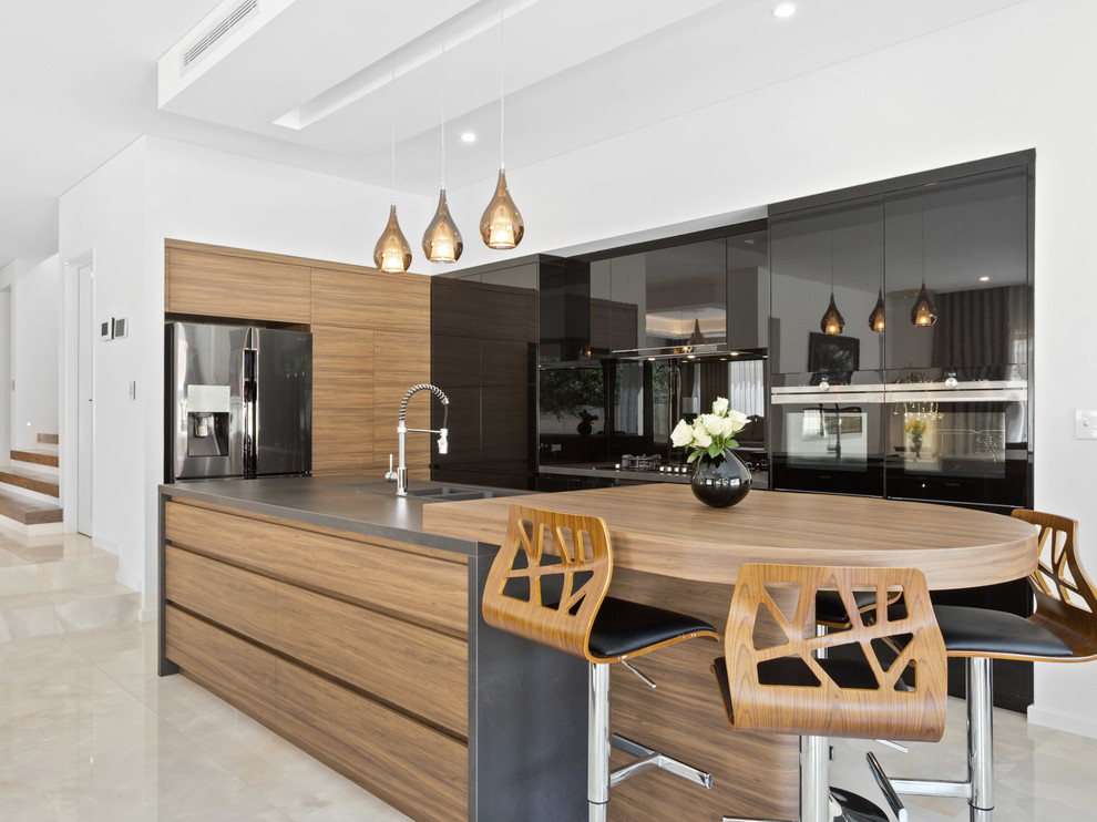 Design ideas for a contemporary l-shaped kitchen in Perth with a double-bowl sink, flat-panel cabinets, medium wood cabinets, wood benchtops, stainless steel appliances, with island, beige floor and brown benchtop.