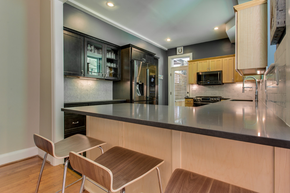 Inspiration for a mid-sized transitional kitchen remodel in DC Metro with recessed-panel cabinets, quartz countertops, stainless steel appliances and a peninsula