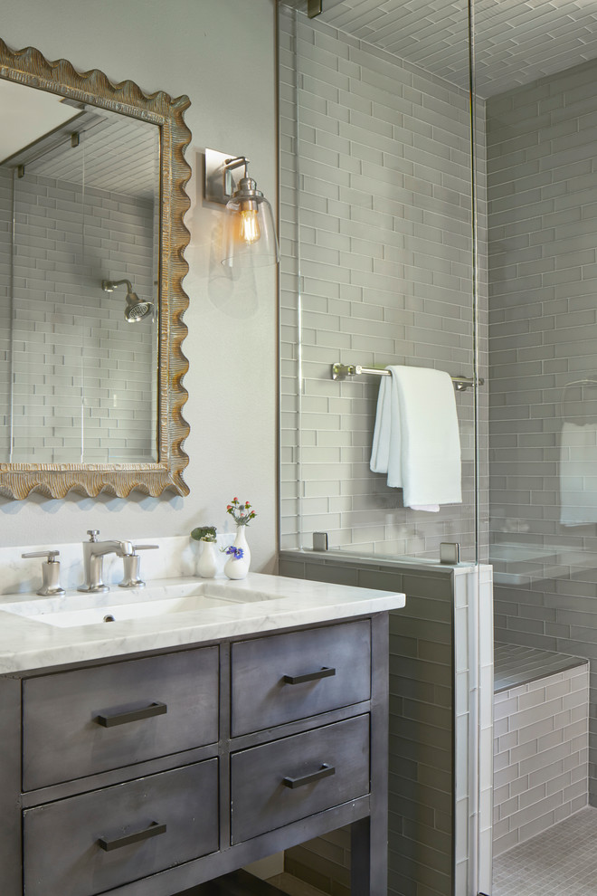 Design ideas for a small country 3/4 bathroom in Austin with flat-panel cabinets, grey cabinets, a one-piece toilet, gray tile, glass tile, grey walls, limestone floors, a drop-in sink, marble benchtops, grey floor, a hinged shower door, white benchtops and an alcove shower.