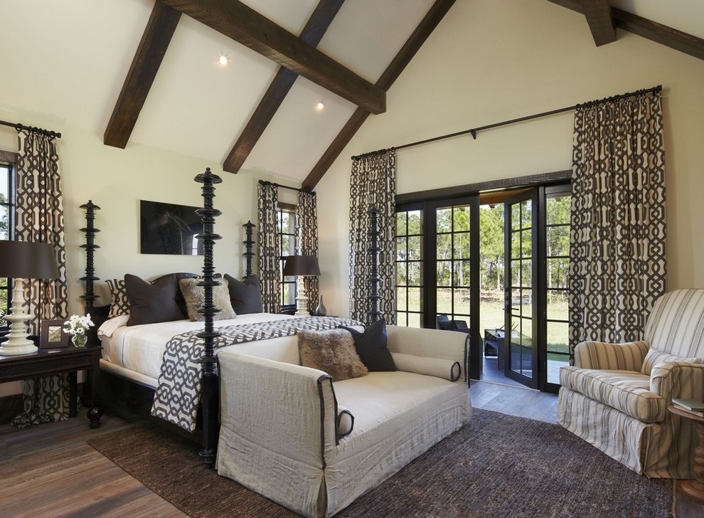 Inspiration for an expansive country bedroom in Miami with white walls and dark hardwood floors.
