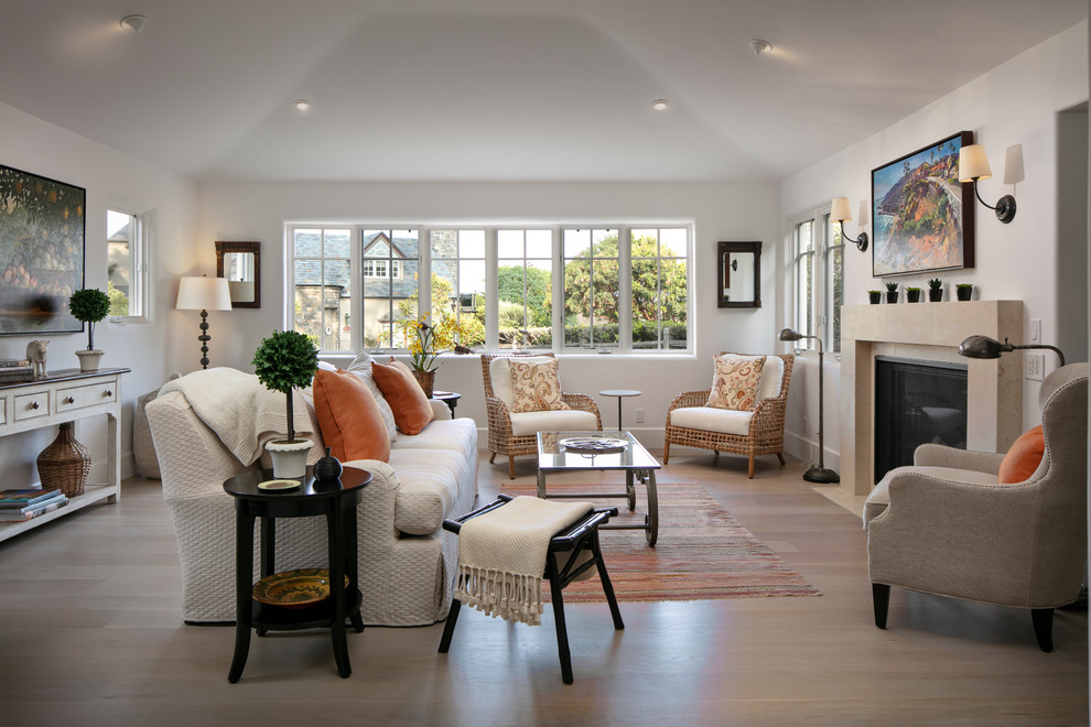 Photo of a transitional living room in Other with white walls, light hardwood floors, a standard fireplace and beige floor.