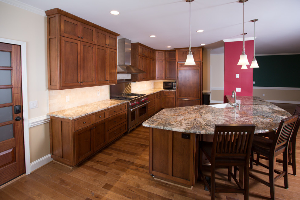 Eat-in kitchen - large transitional l-shaped dark wood floor eat-in kitchen idea in Charlotte with an undermount sink, raised-panel cabinets, white cabinets, granite countertops, beige backsplash, subway tile backsplash, stainless steel appliances and an island