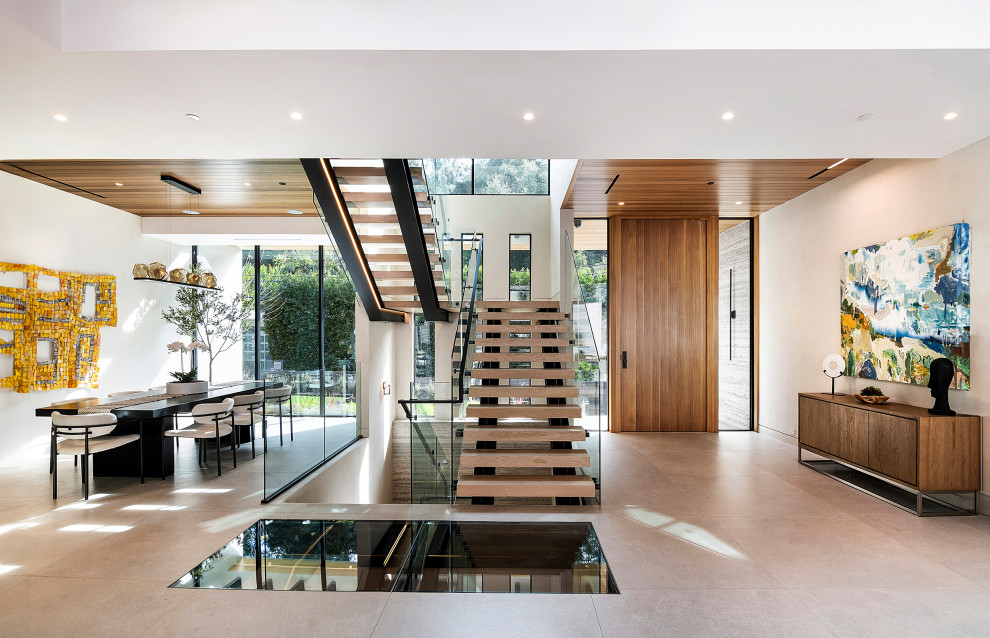 Inspiration for a large contemporary wooden floating open and glass railing staircase remodel in Los Angeles